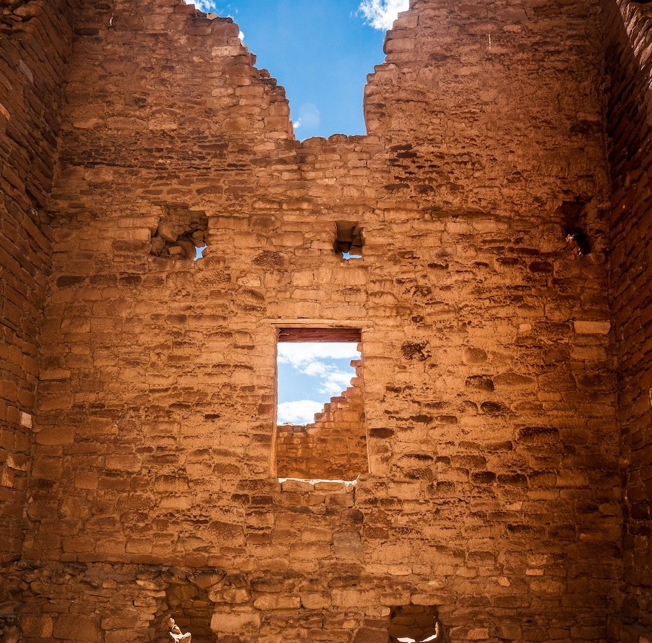 A tall adobe wall with a window at Chaco Culture National Historical Park